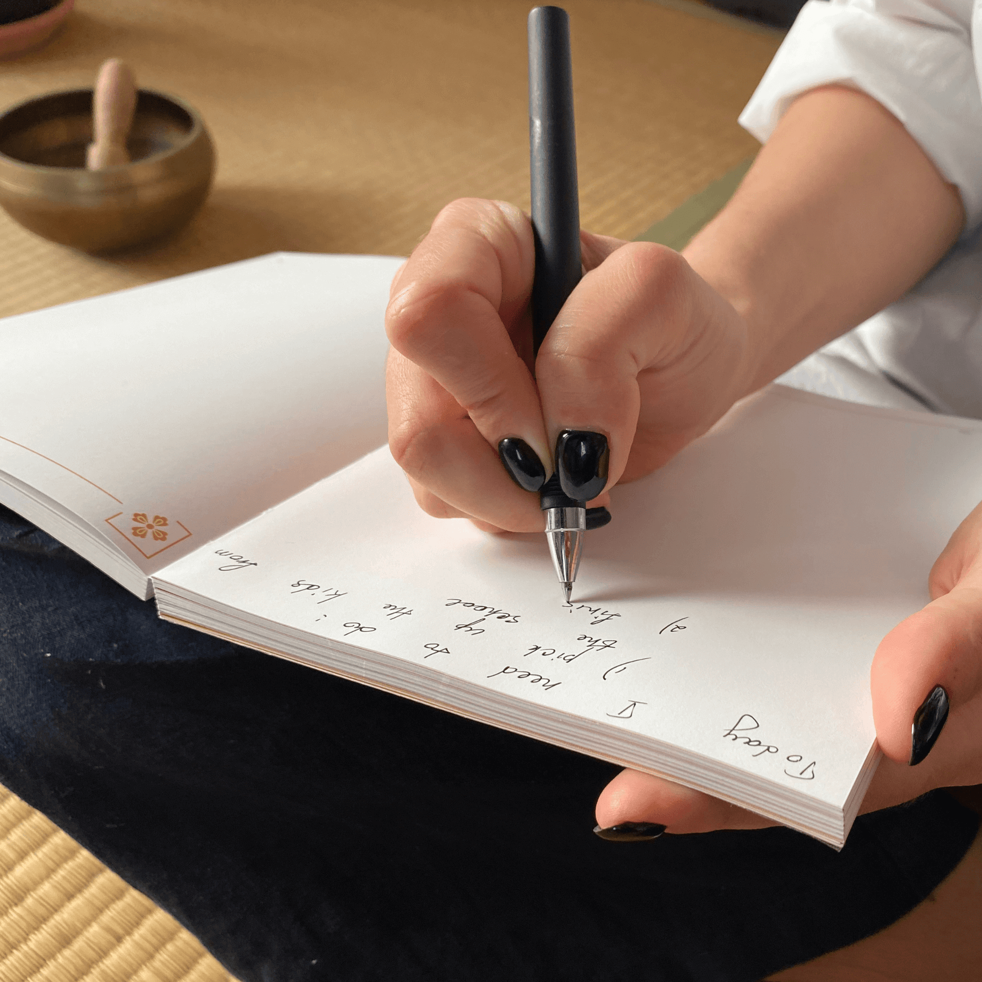 Writing affirmations in a meditation journal.