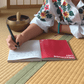 Woman writing a gratitude list in a meditation journal.