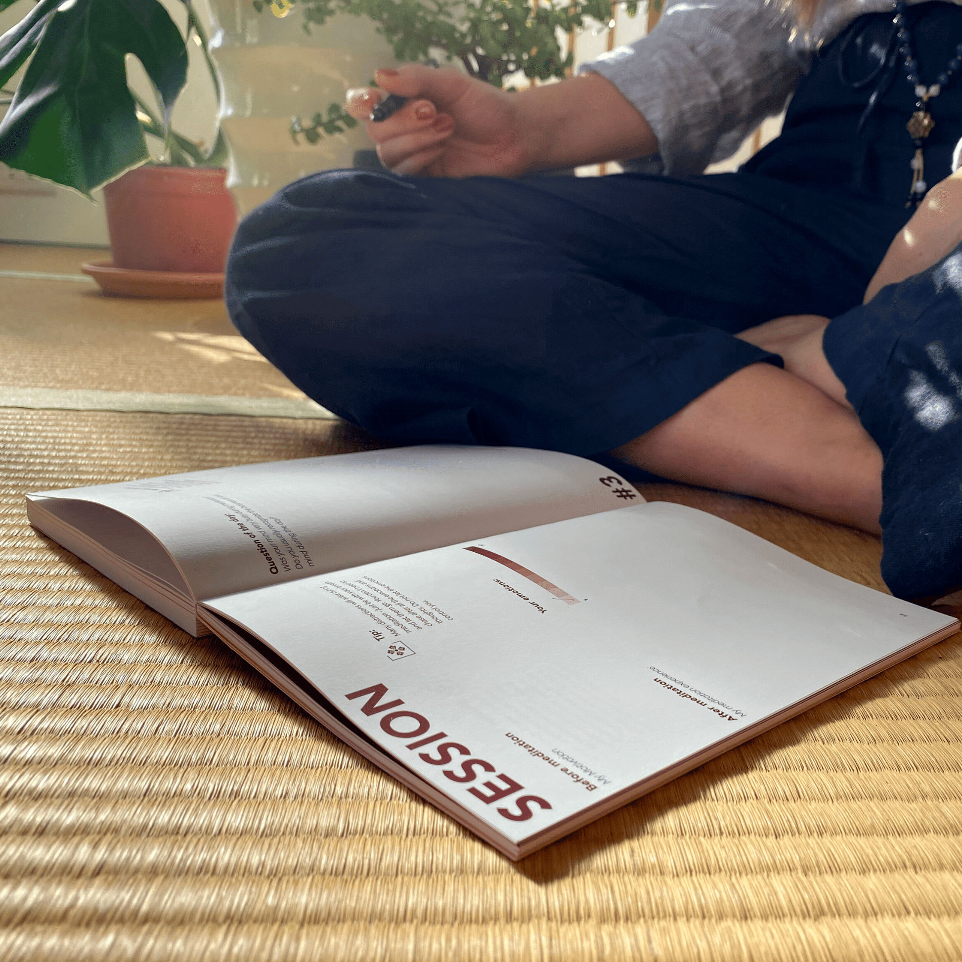 Woman meditating with a mindfulness journal.
